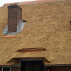 Een ingedekte koperen goot boven de voordeur